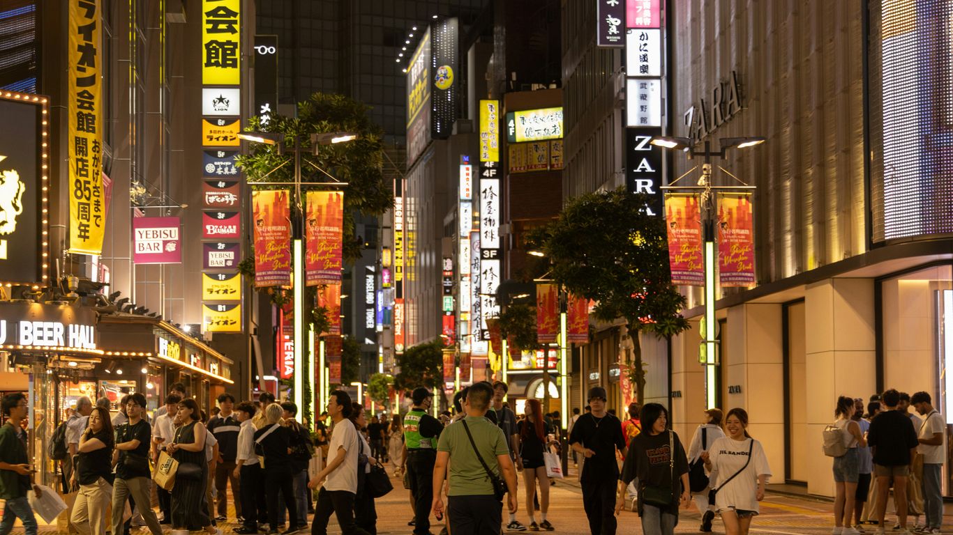 Neon lights brighten a nightlife street