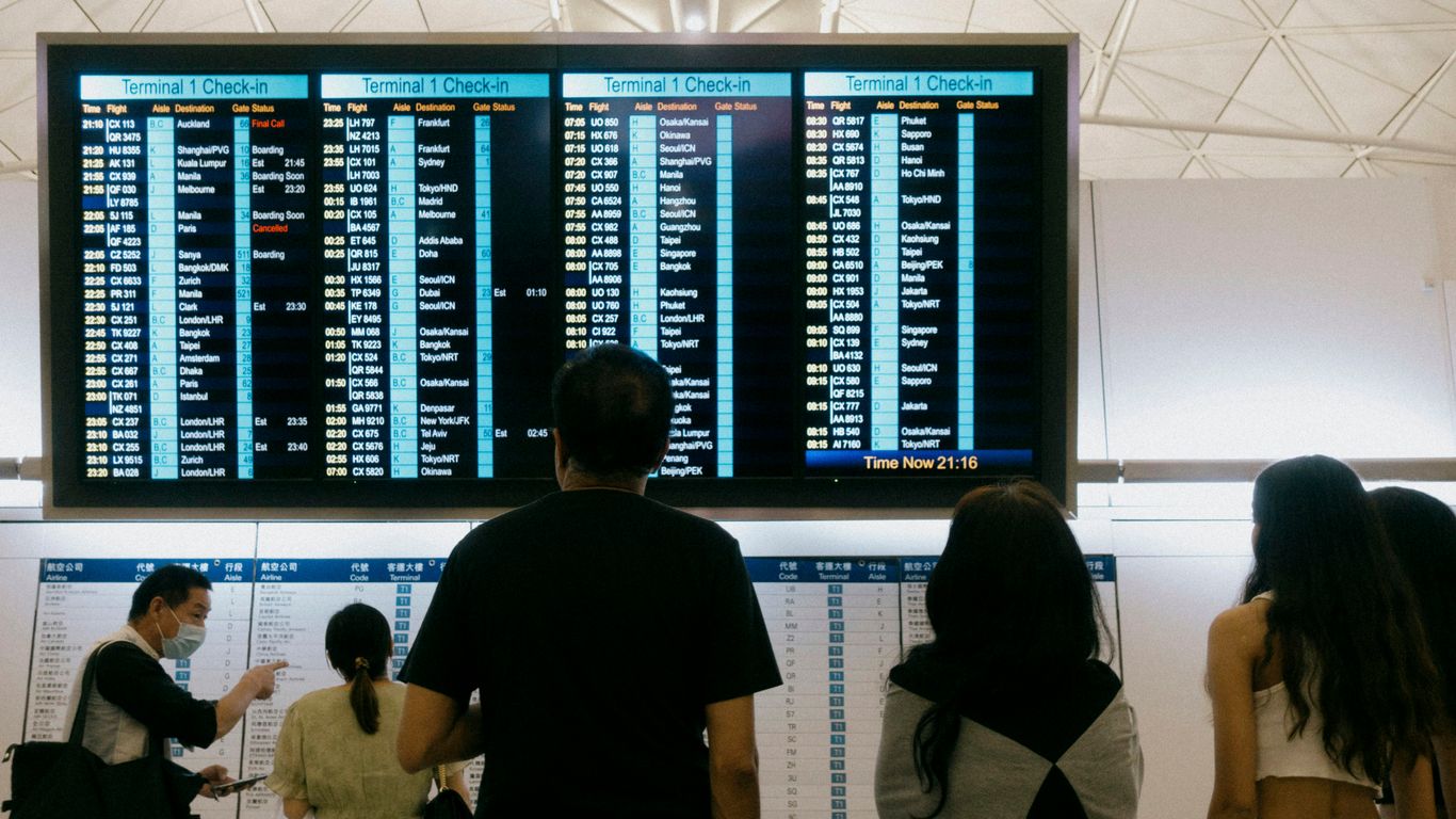 a group of people standing in front of a large screen