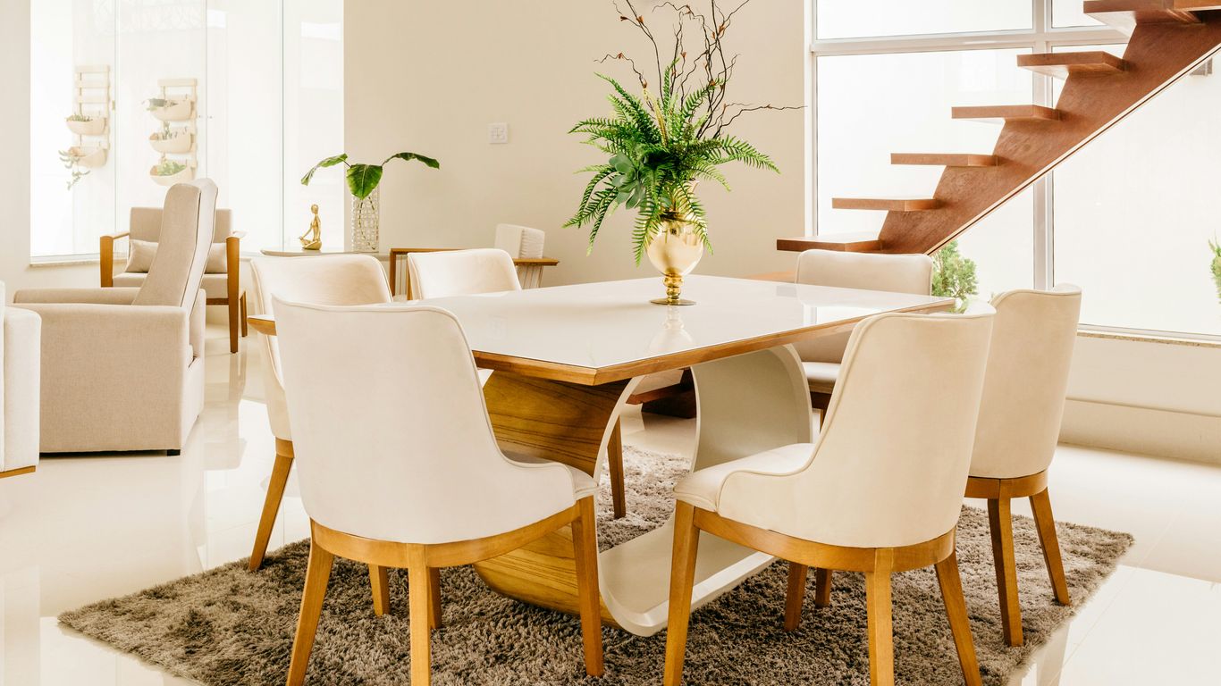 Dining chairs arranged around marble table