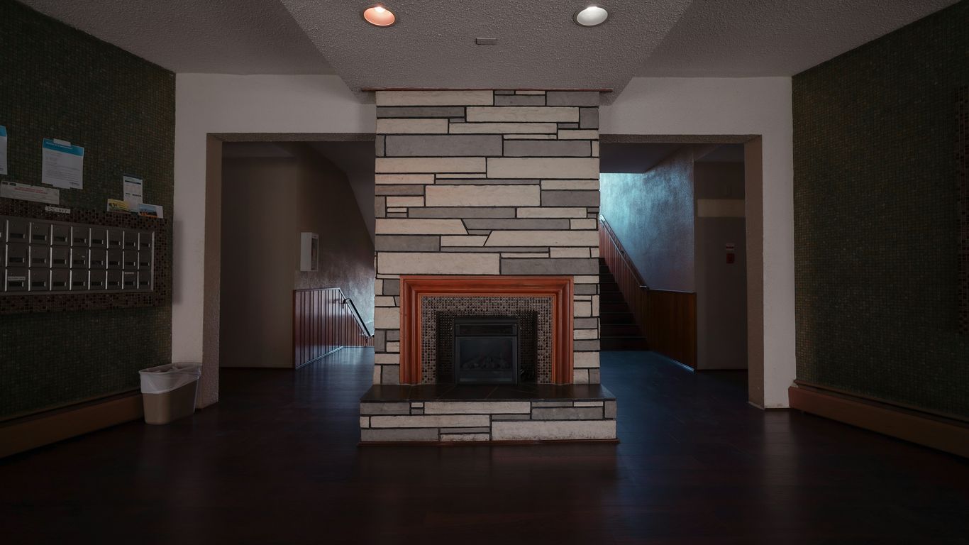 a living room with a fireplace and a fire place