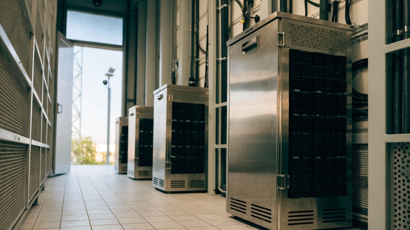 Telecom battery cabinets beside a 5G tower