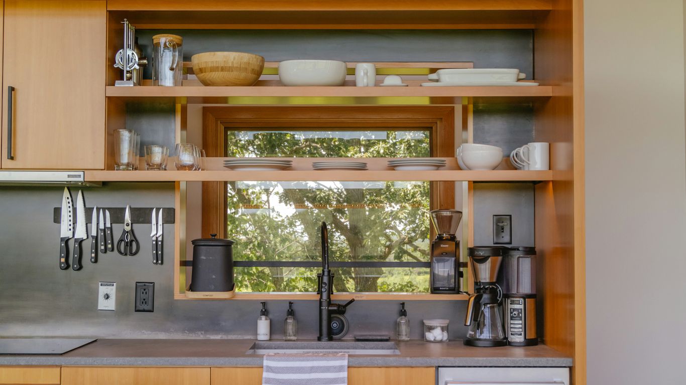 a kitchen with a sink and a mirror