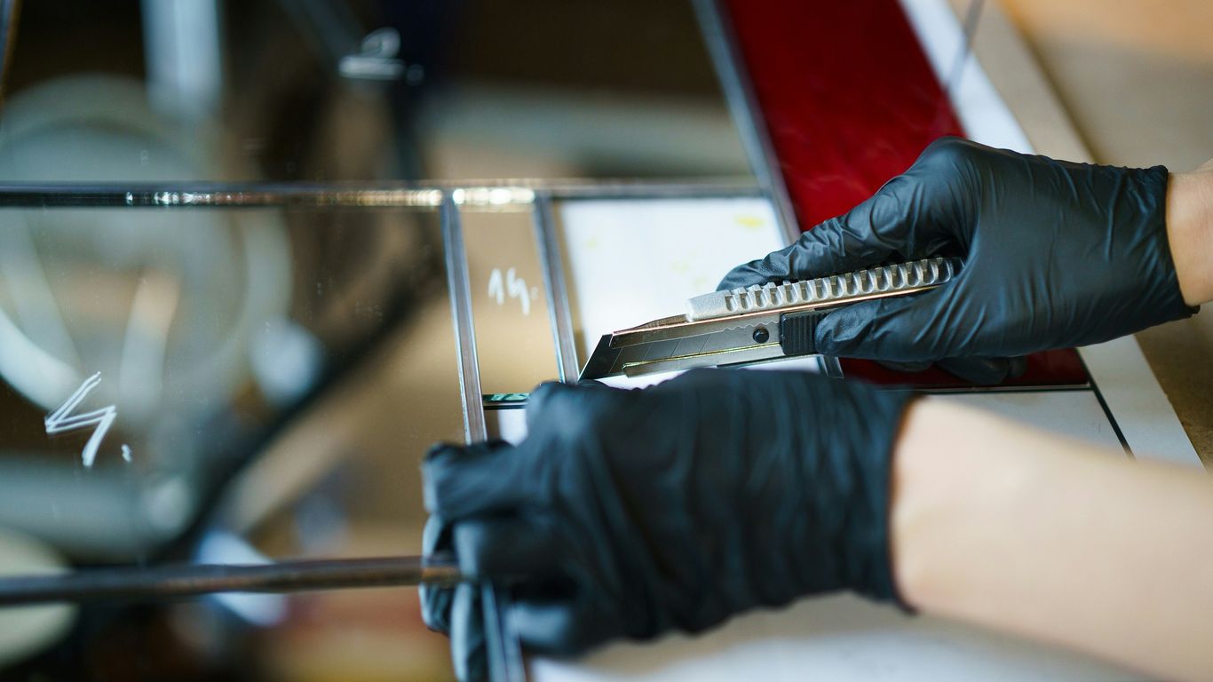 a pair of black gloves are being used on a machine