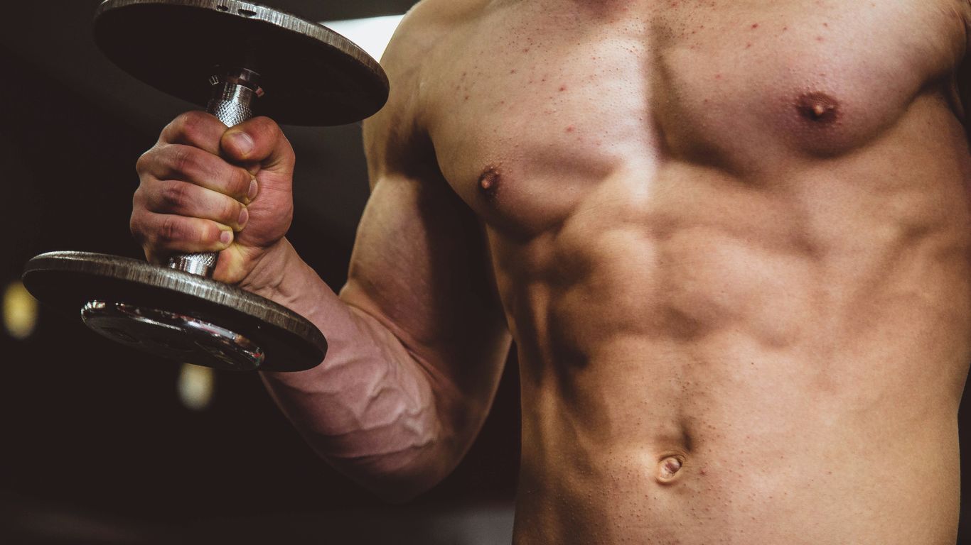 man holding black dumbbell