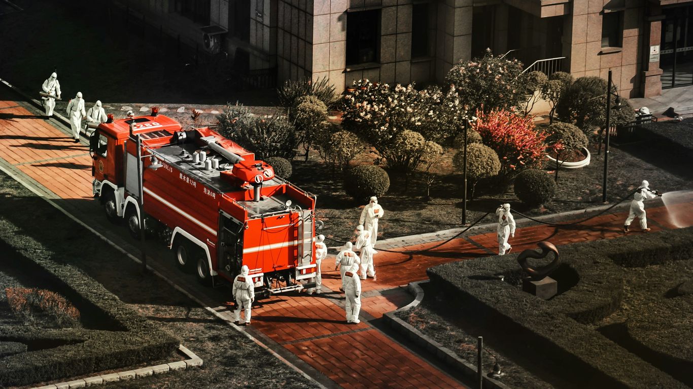 a large red truck with people standing around it