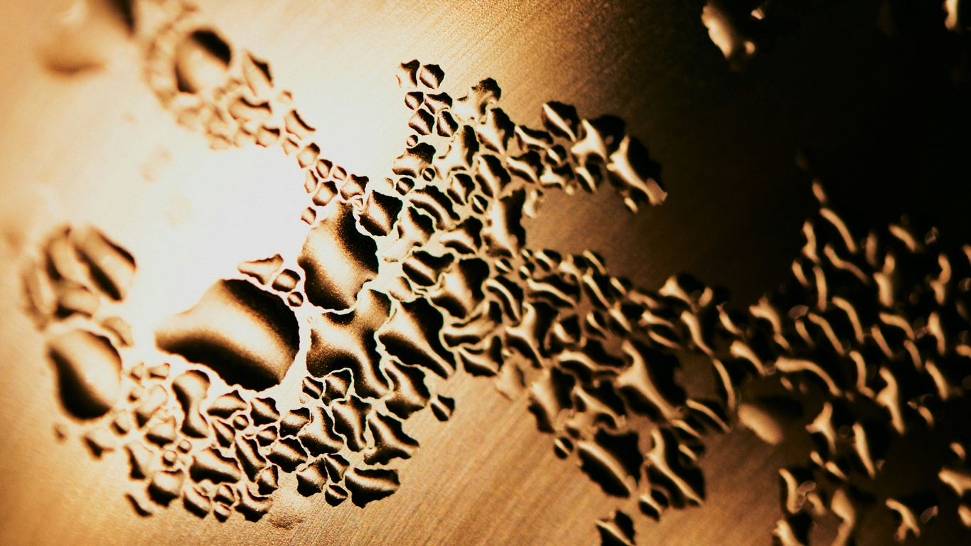 silver chain link on brown wooden table