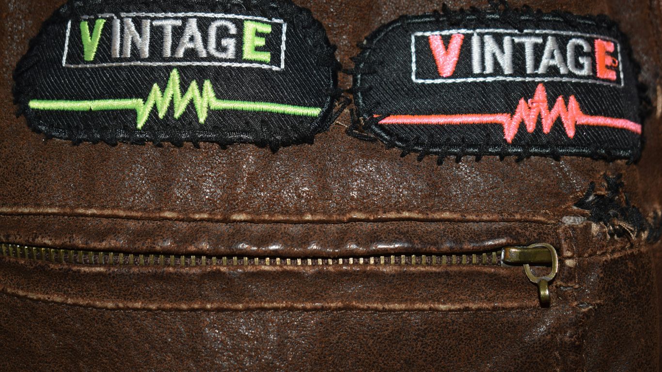 Two vintage patches on a brown leather jacket