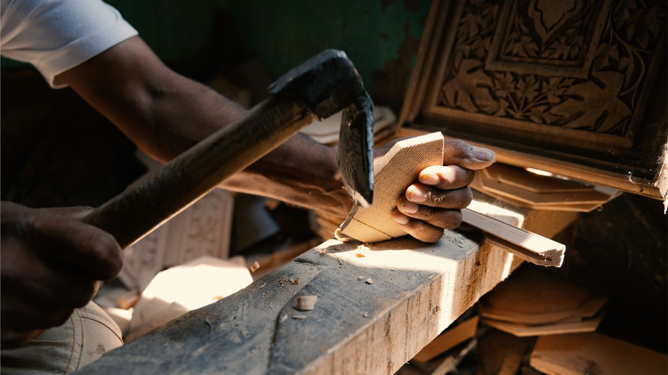 Stone artisan shaping a curved component