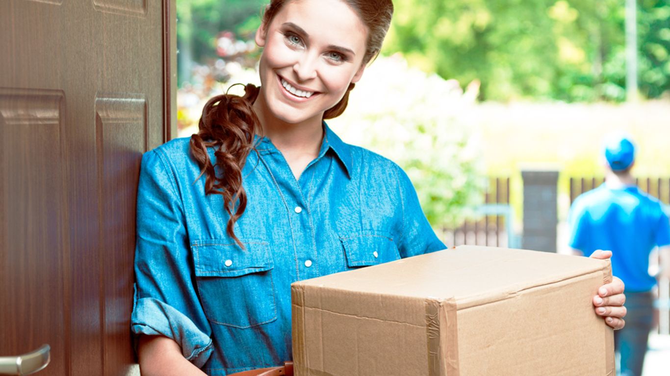 A person receives a package at their doorstep from a delivery person.
