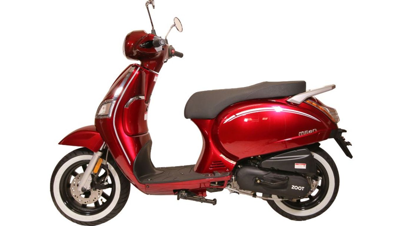 A shiny red Milan Zoot scooter with white-walled tires.