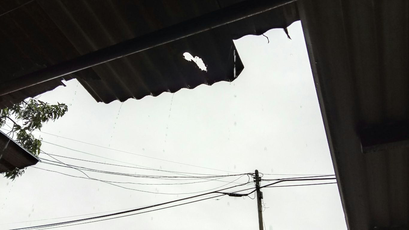 a view of a street with a telephone pole in the foreground