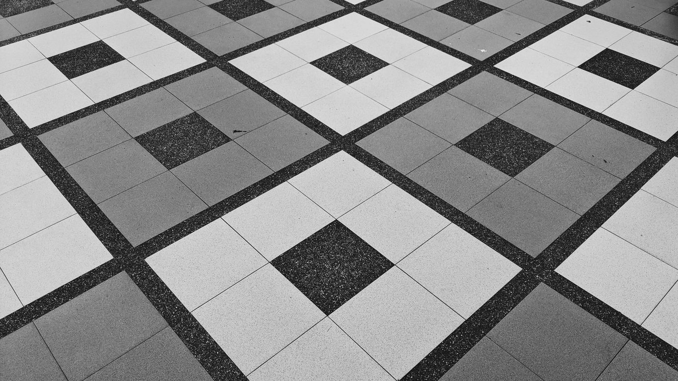 Patterned tiles beneath a Singapore shophouse window