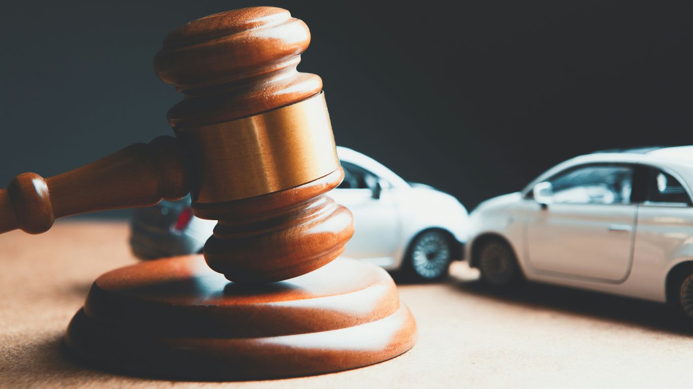 a toy car and a wooden gaven on a table