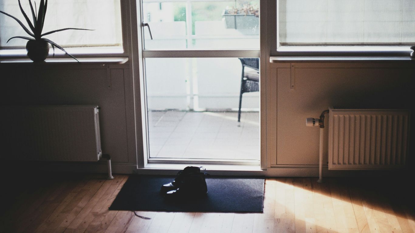 black puppy on door mat inside room