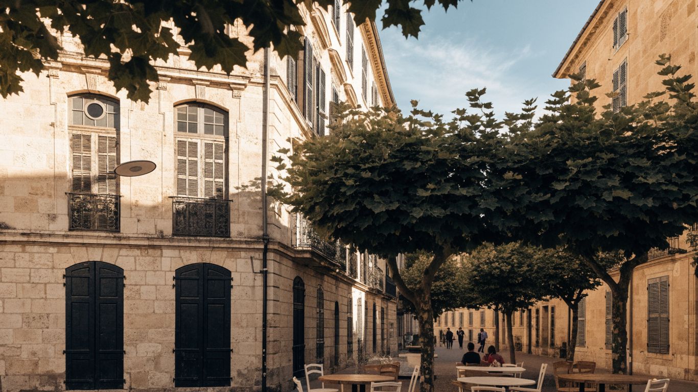 Historic Aix square with café tables