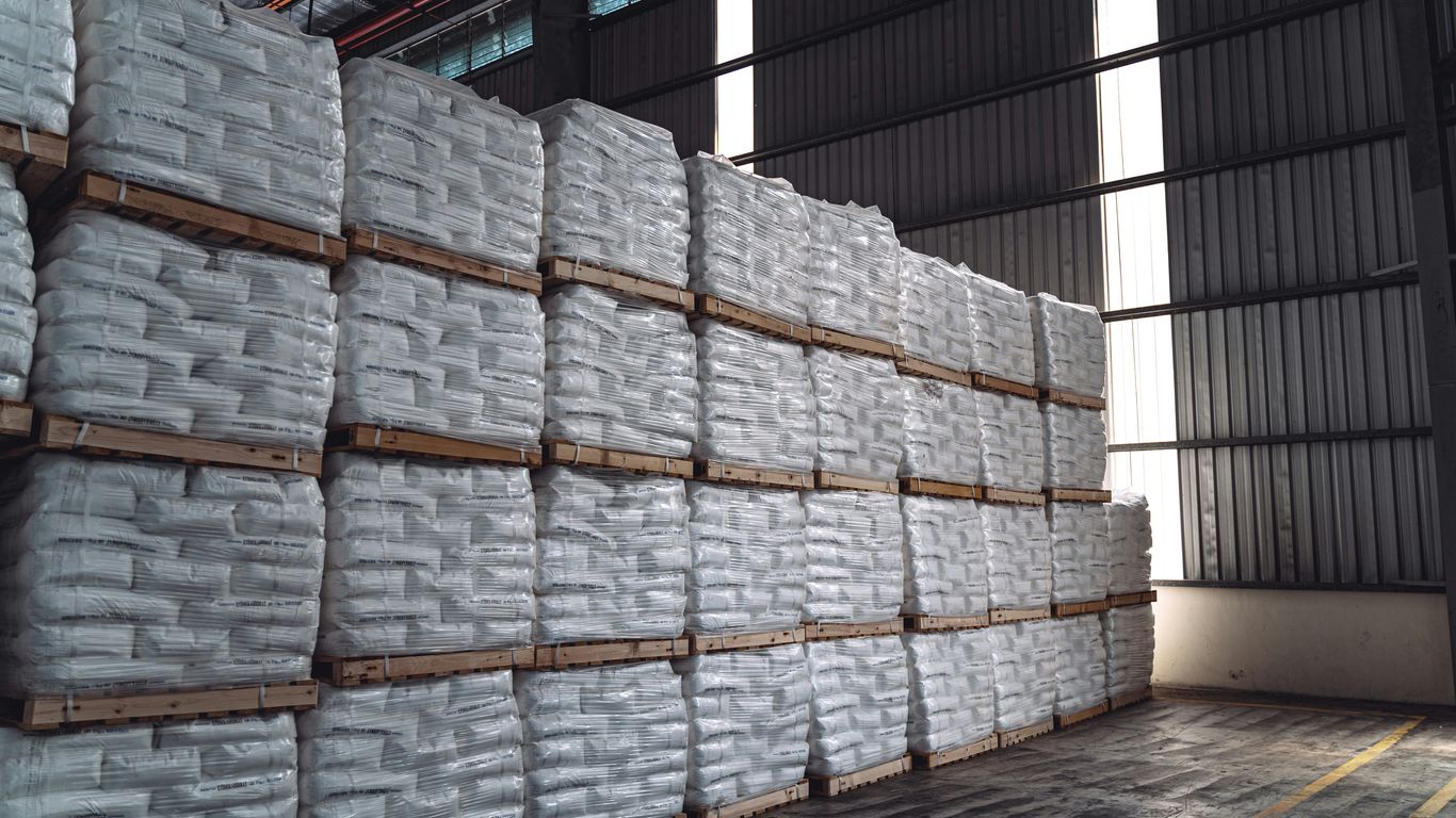 a warehouse filled with stacks of white bags