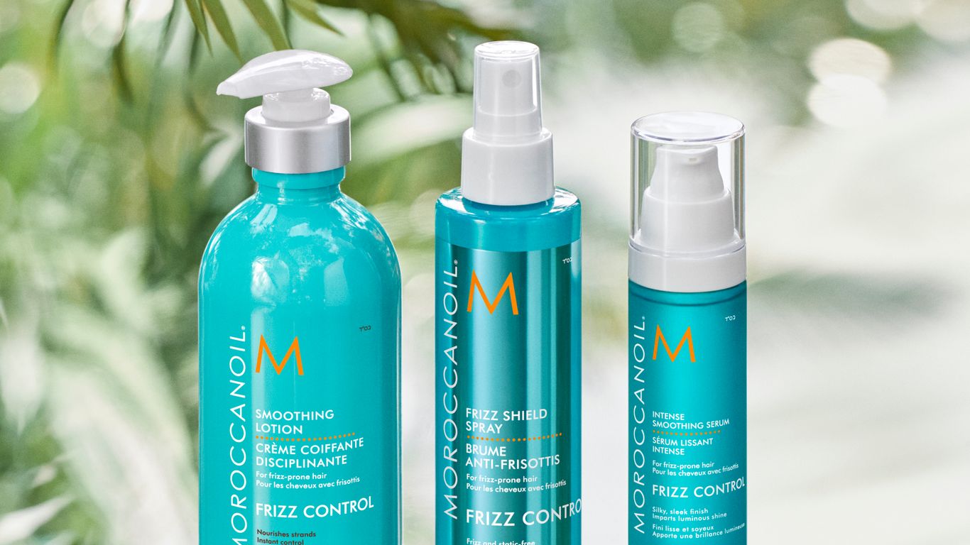 Haircare products displayed amidst lush greenery.