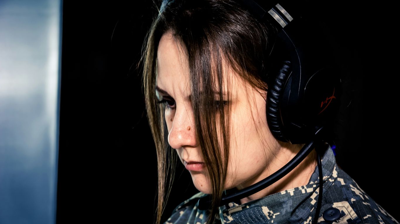 a woman wearing a headset and looking down