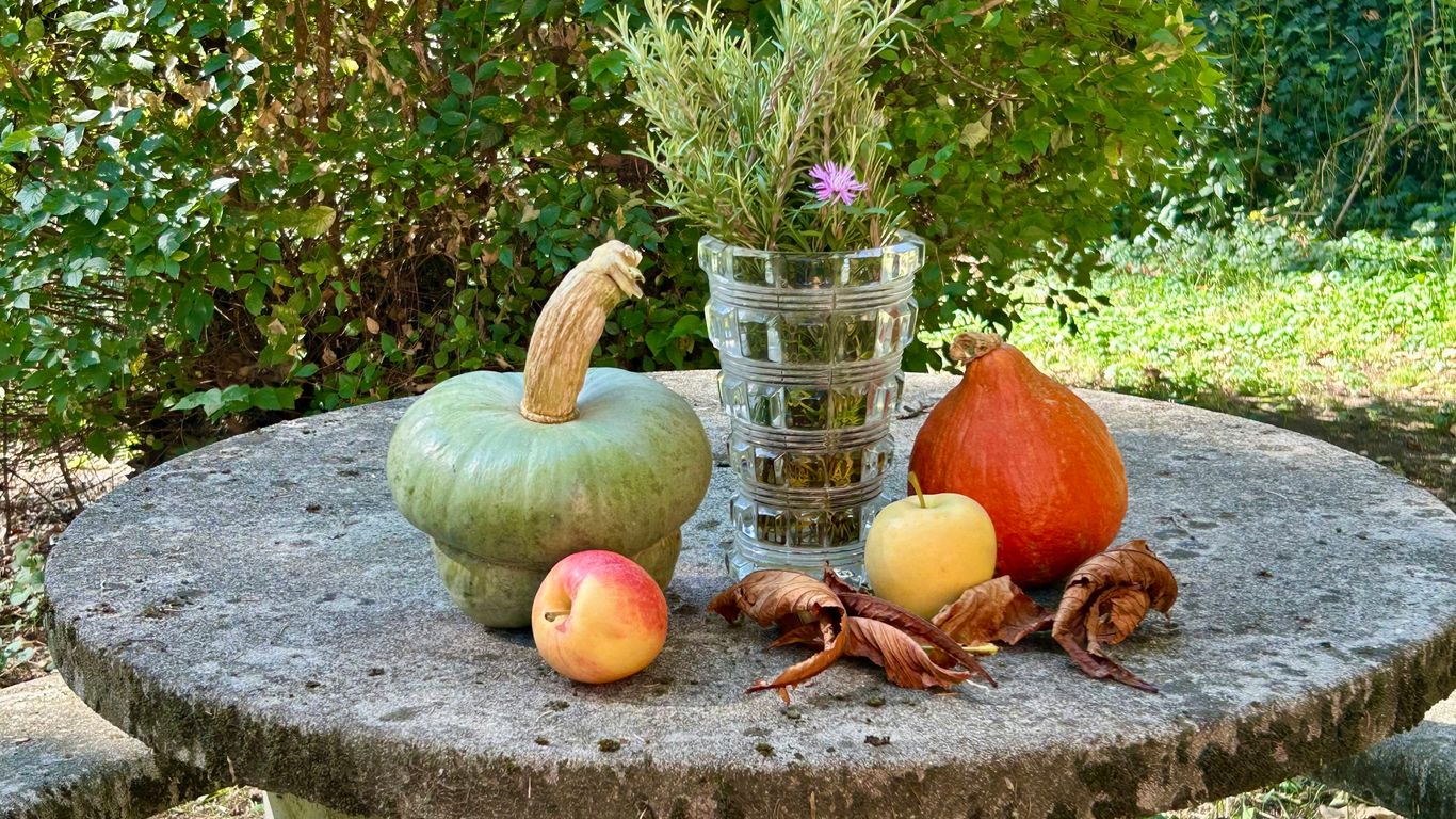 Autumn harvest vegetables and fruits on a stone table.
