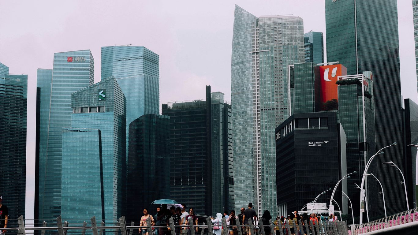 people walking on bridge surrounded with buildings