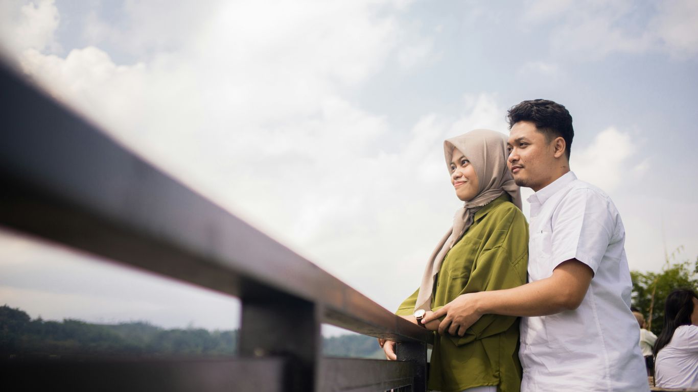 a man and woman standing outside