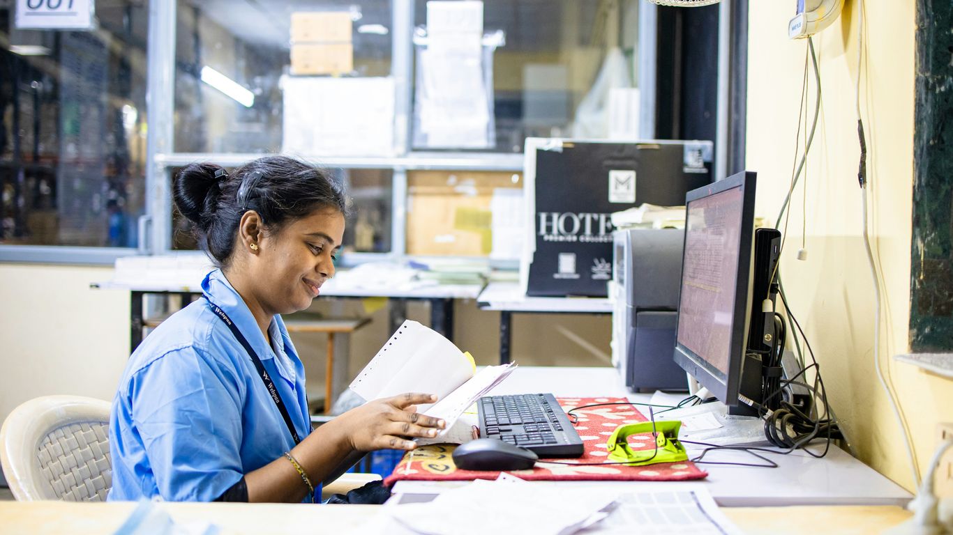 Woman works at her desk in an office.