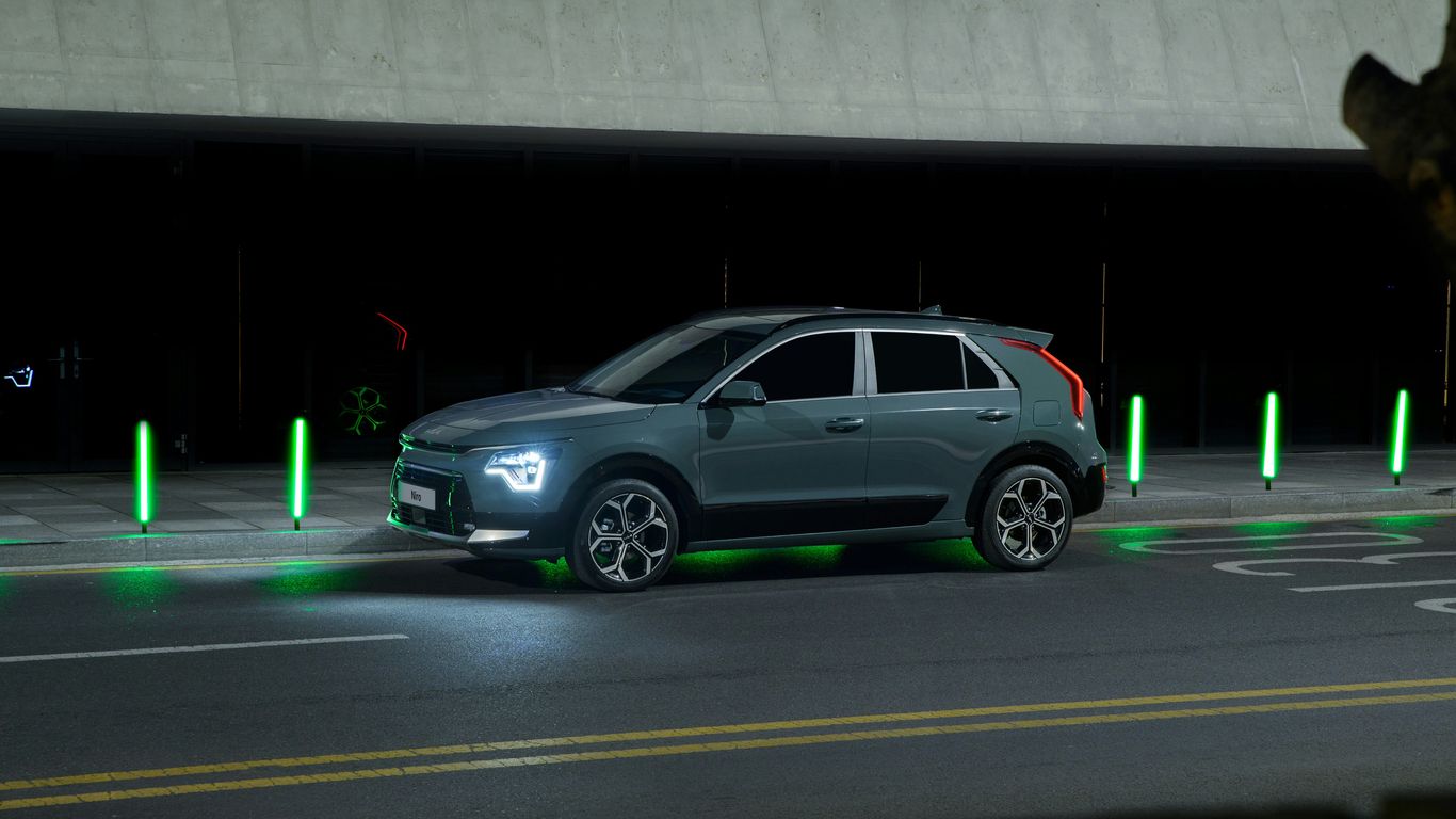 a car driving down a street at night