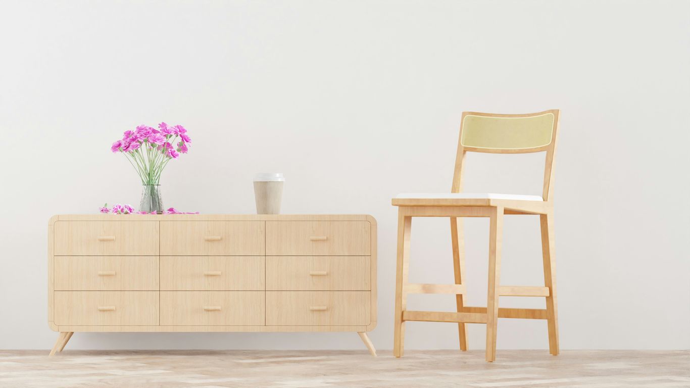 A wooden chair in an open, sunlight-filled living room.