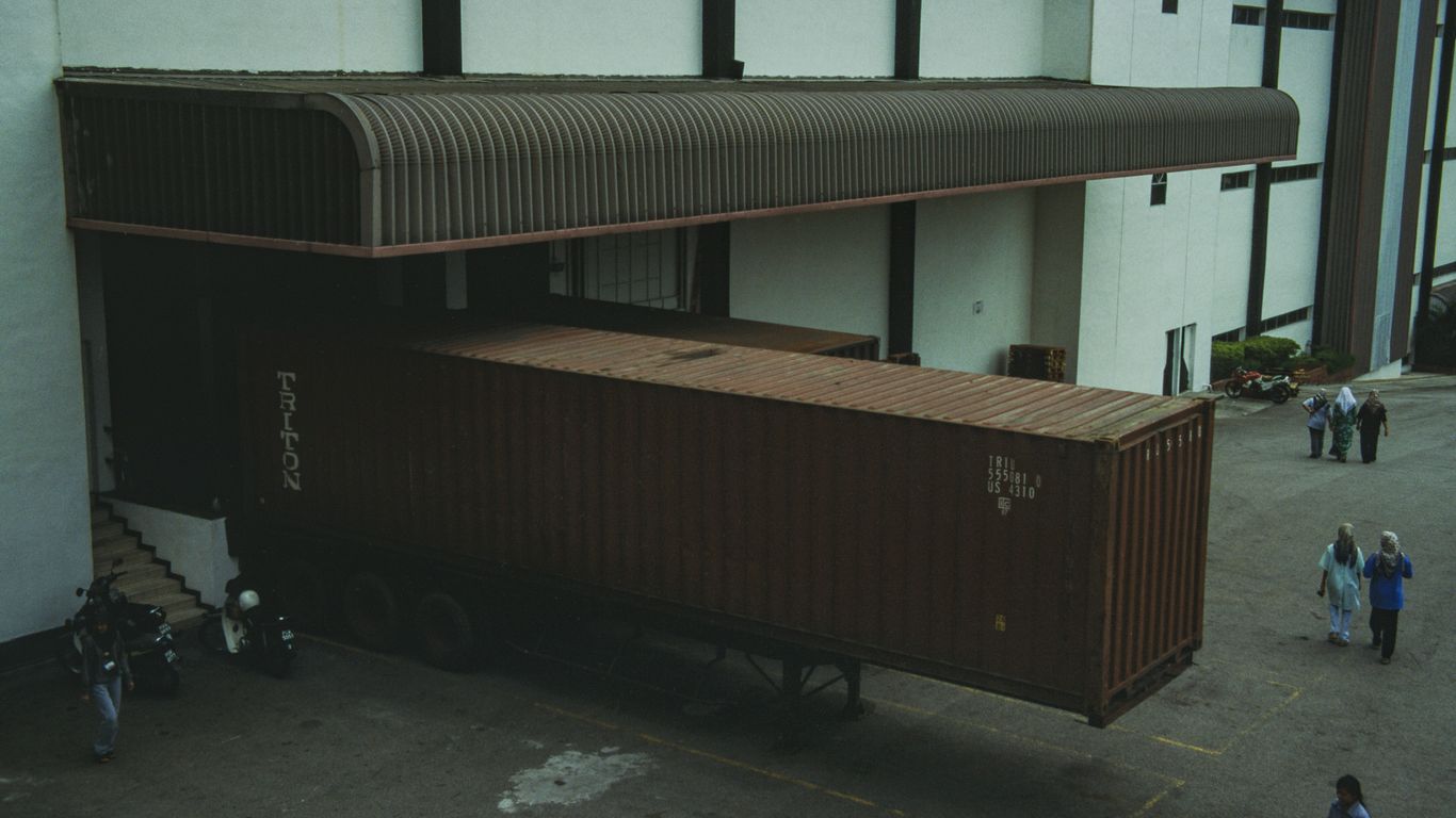 A group of people walking around a building