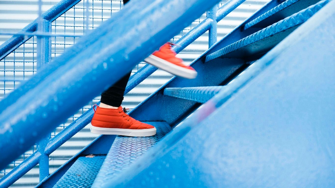 person stepping on blue stairs