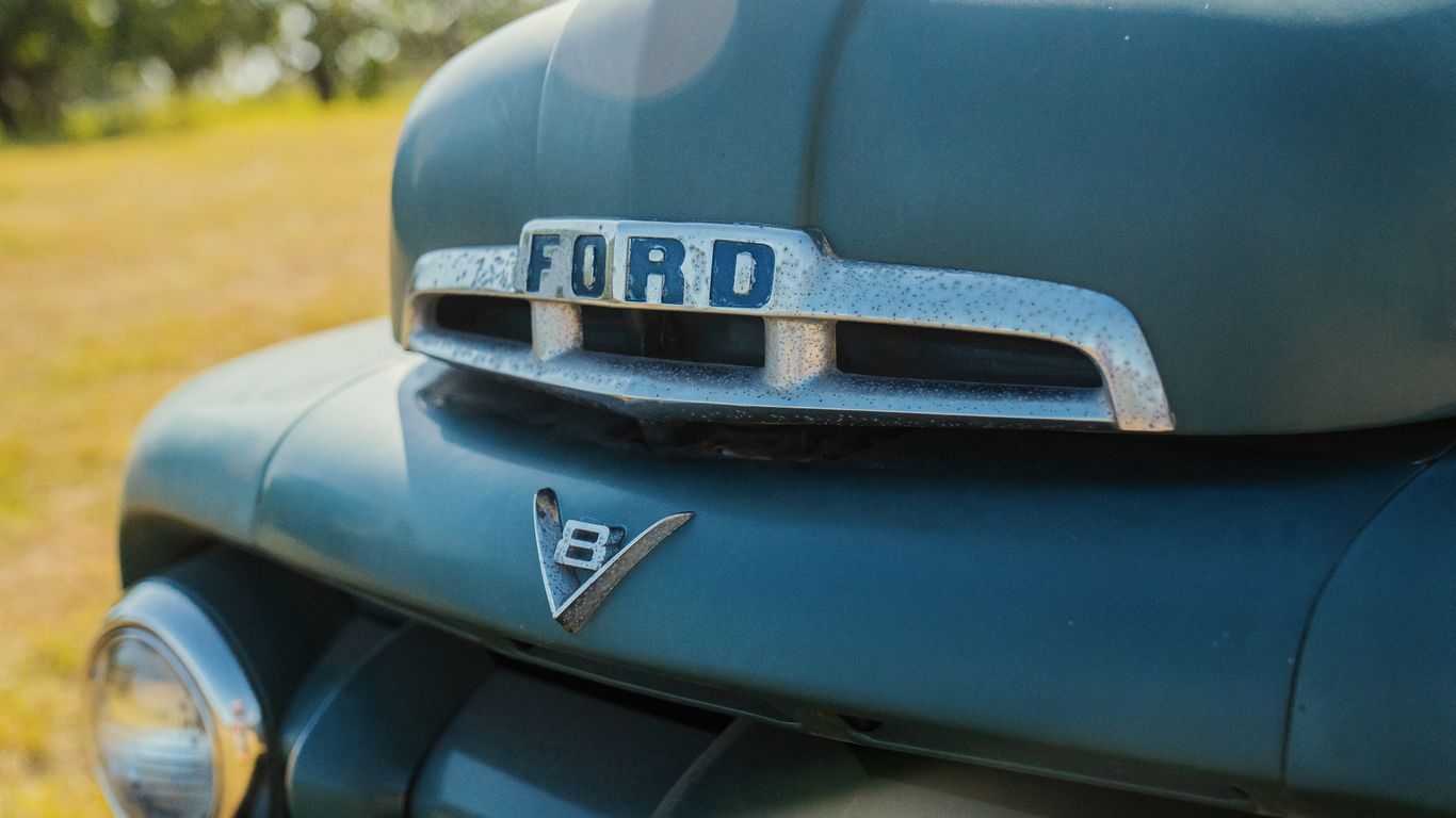 a close up of the front end of a green car