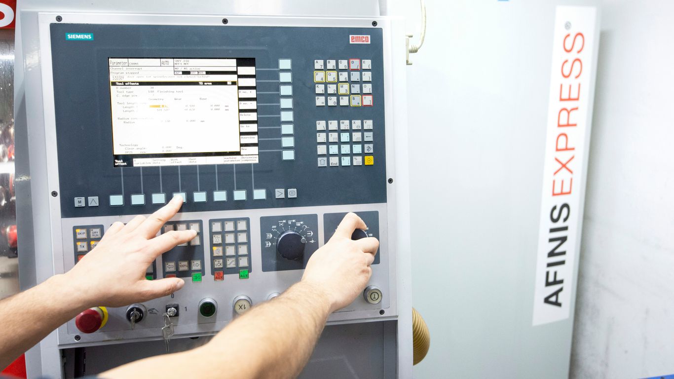 a man operating a machine in a factory