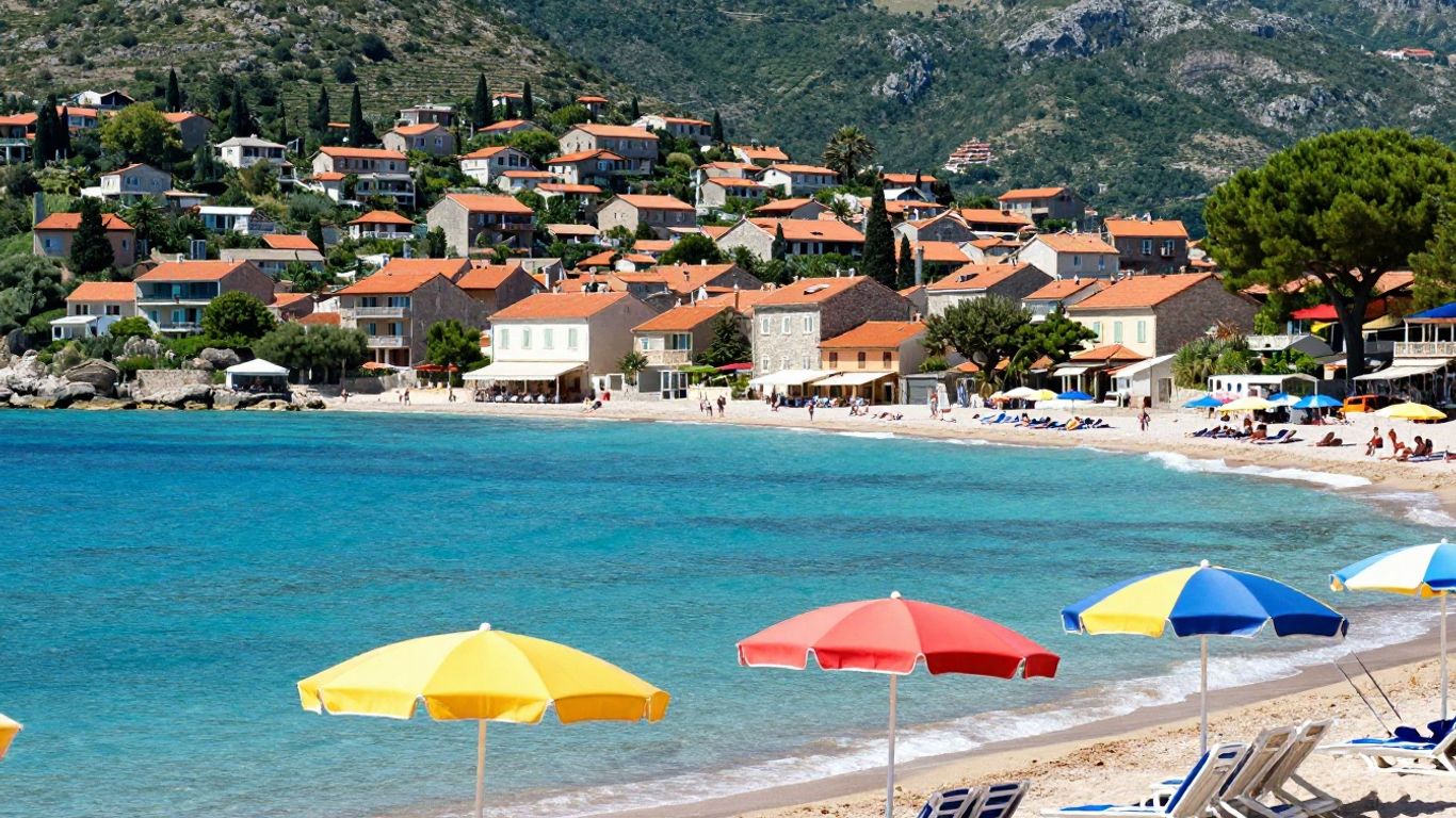 Sunny European beach with village and hills.