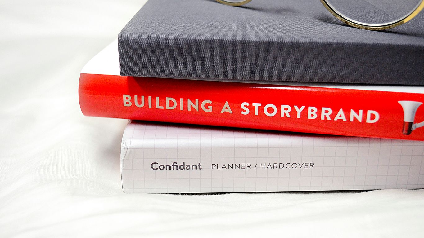 gold framed eyeglasses on black hardbound book