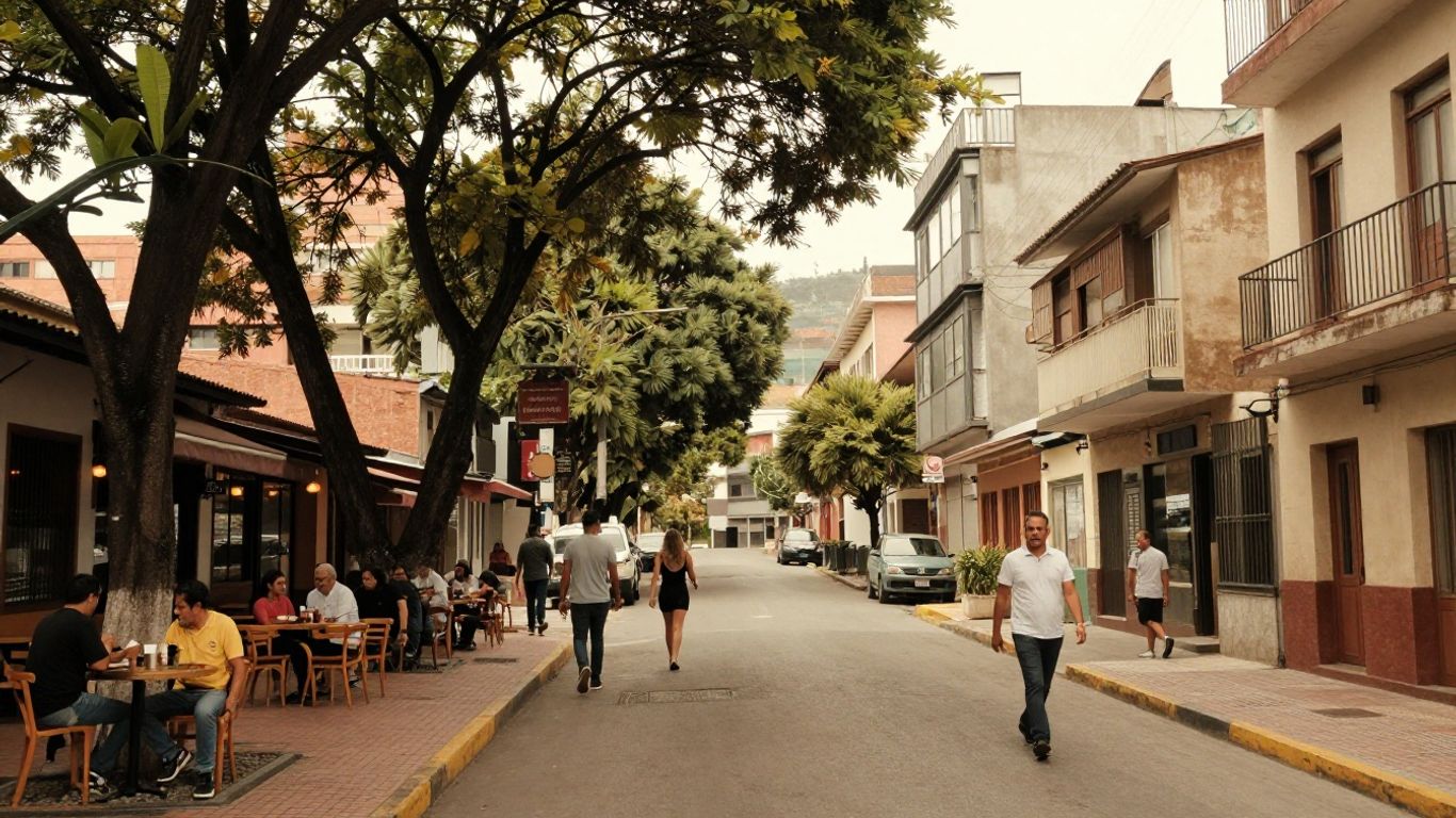Leafy Laureles street with walkers and cafés