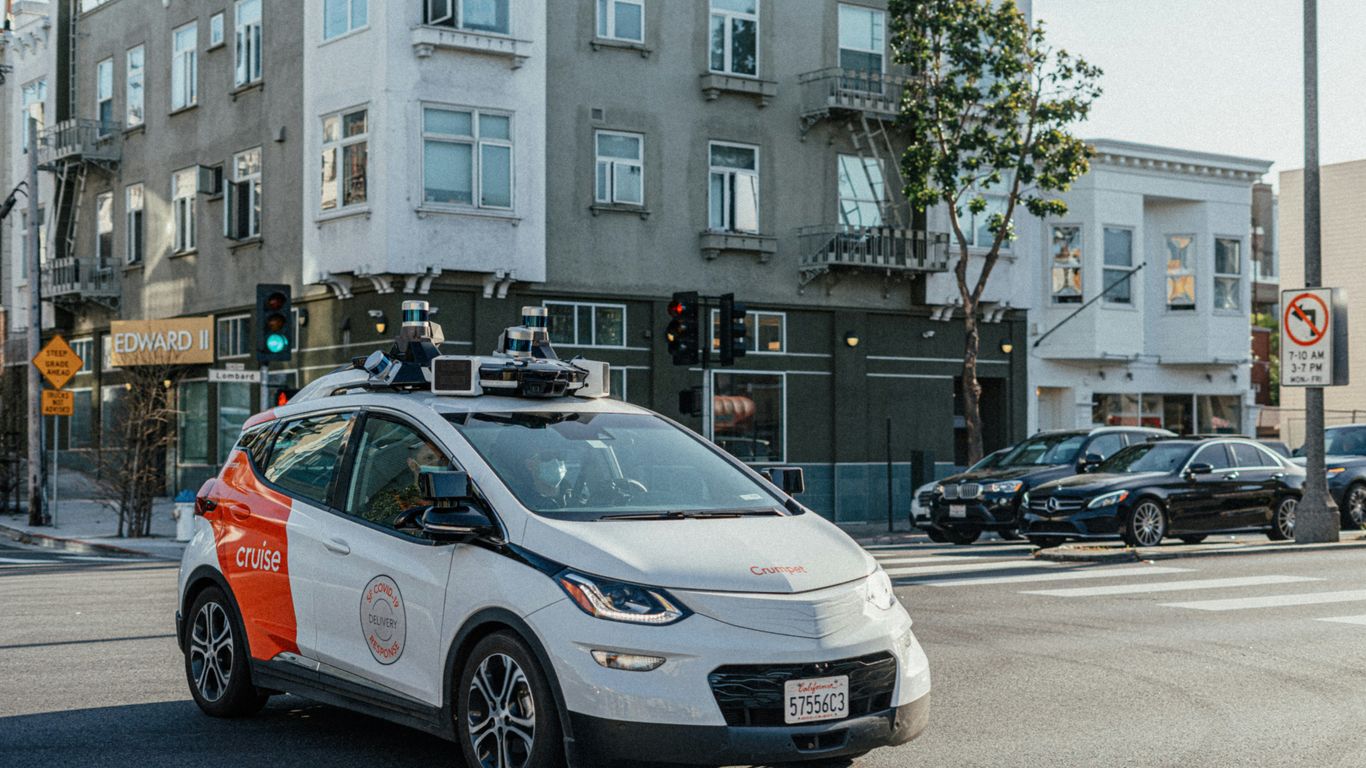 Autonomous vehicle moving through city traffic