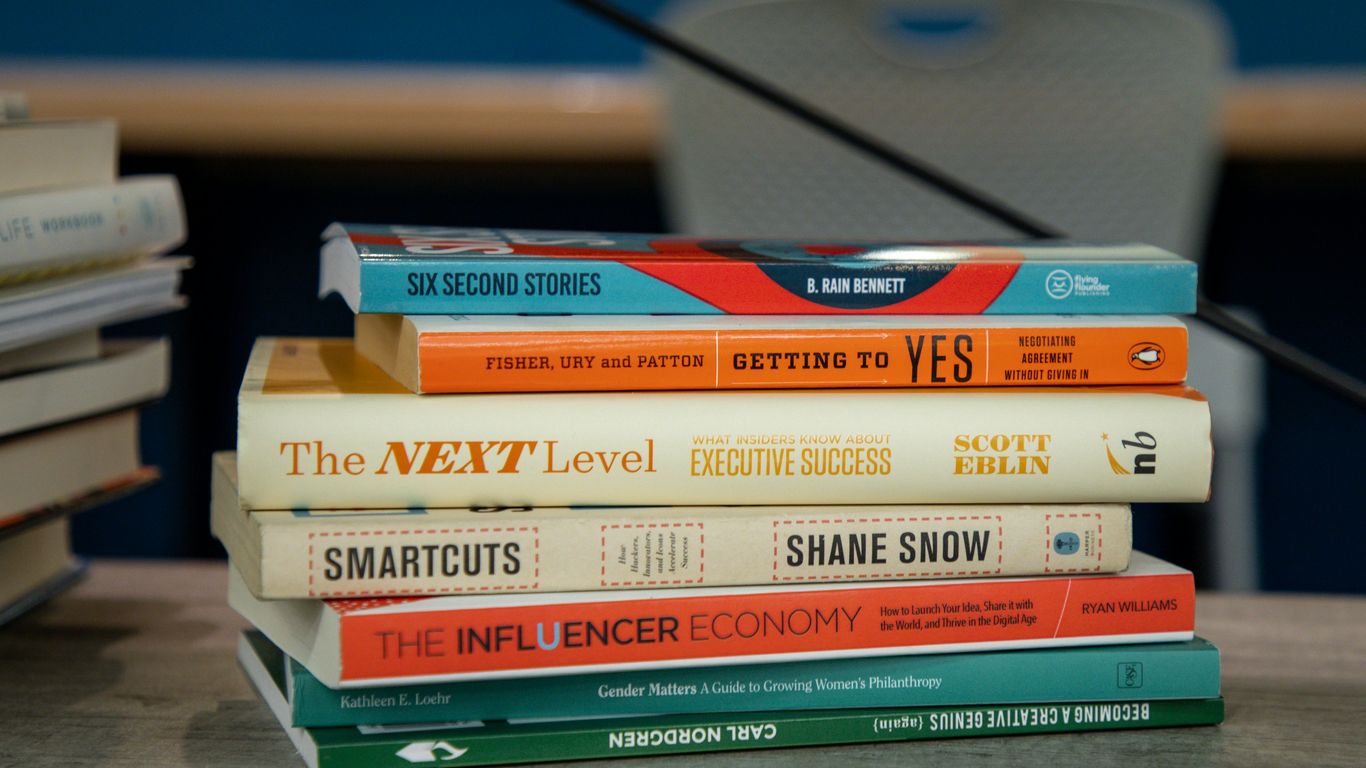 a stack of books sitting on top of a table