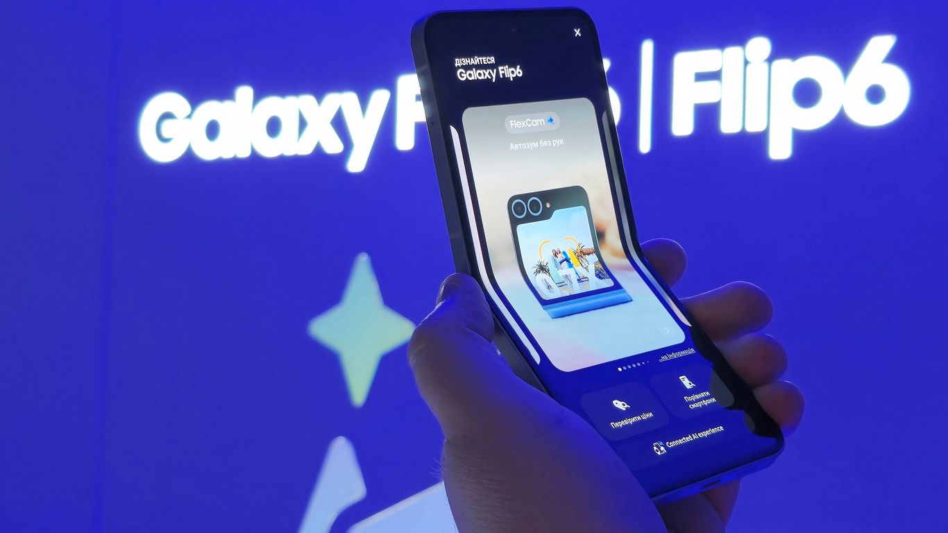 A person holding a smart phone in their hand