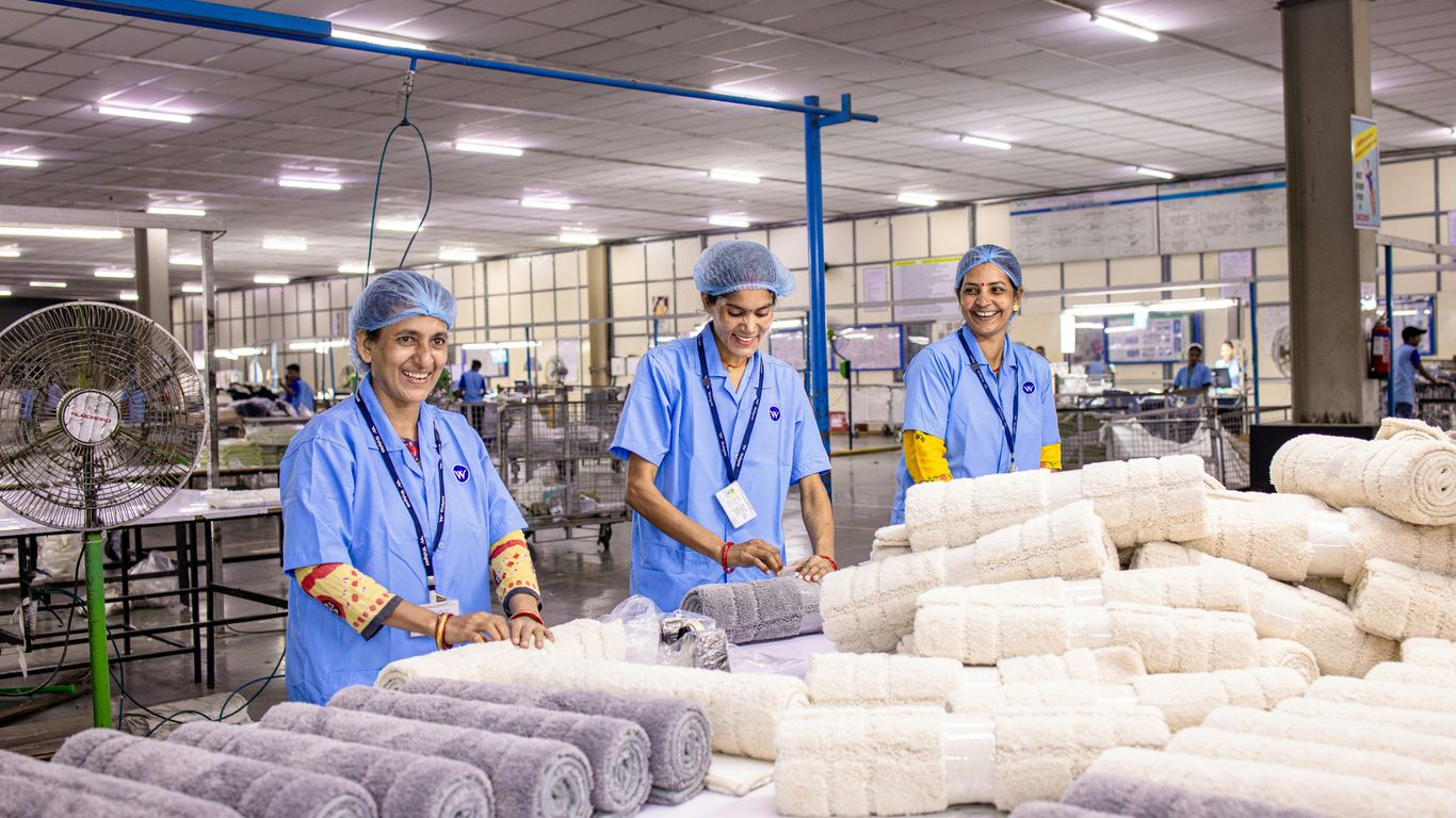 Inspector checking folded towels in warehouse