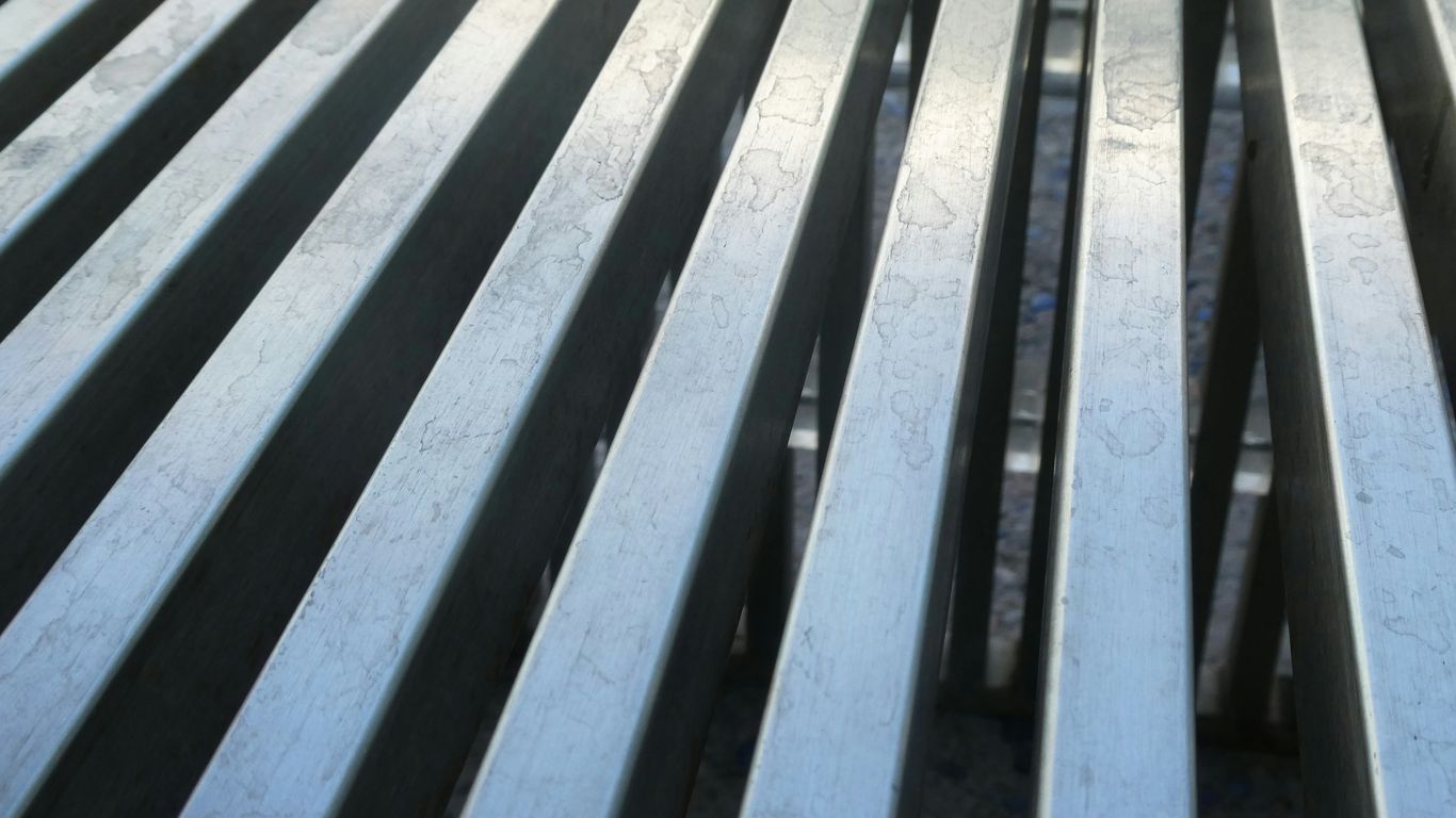 Parallel, metallic lines create a textured surface.