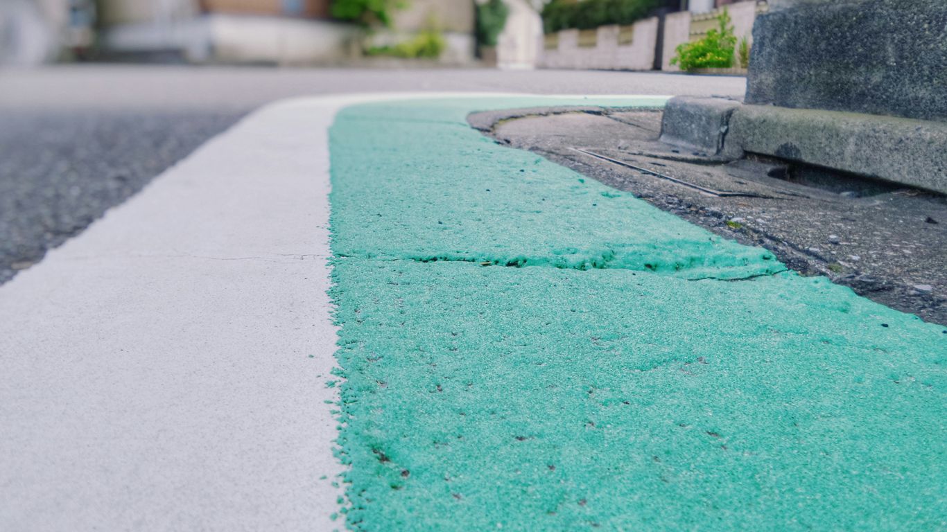 closeup photo of white and teal painted corner street