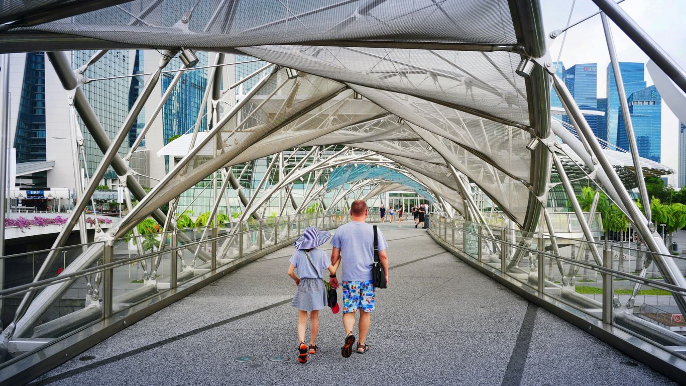 man and woman walking inside clear glass roof pathway at daytime
