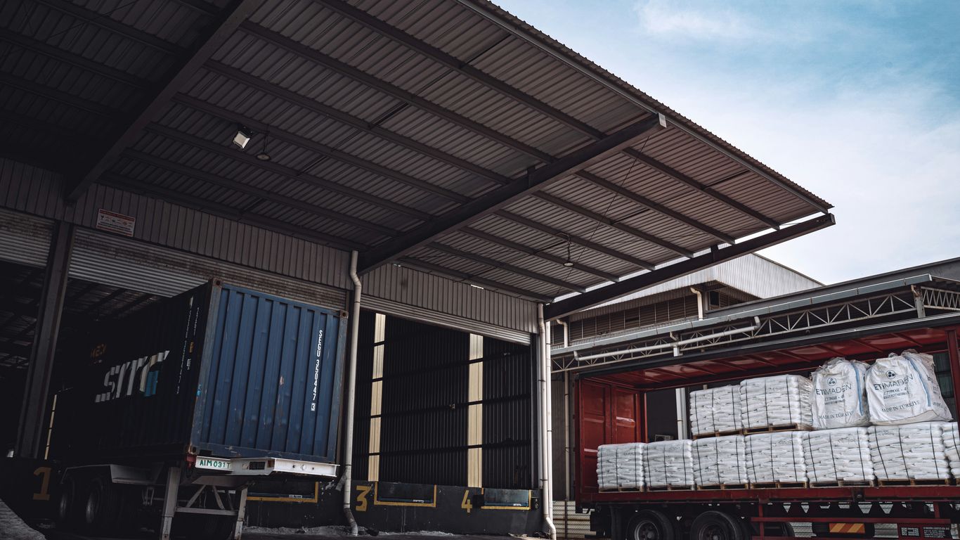 Workers sorting packages in a busy loading bay