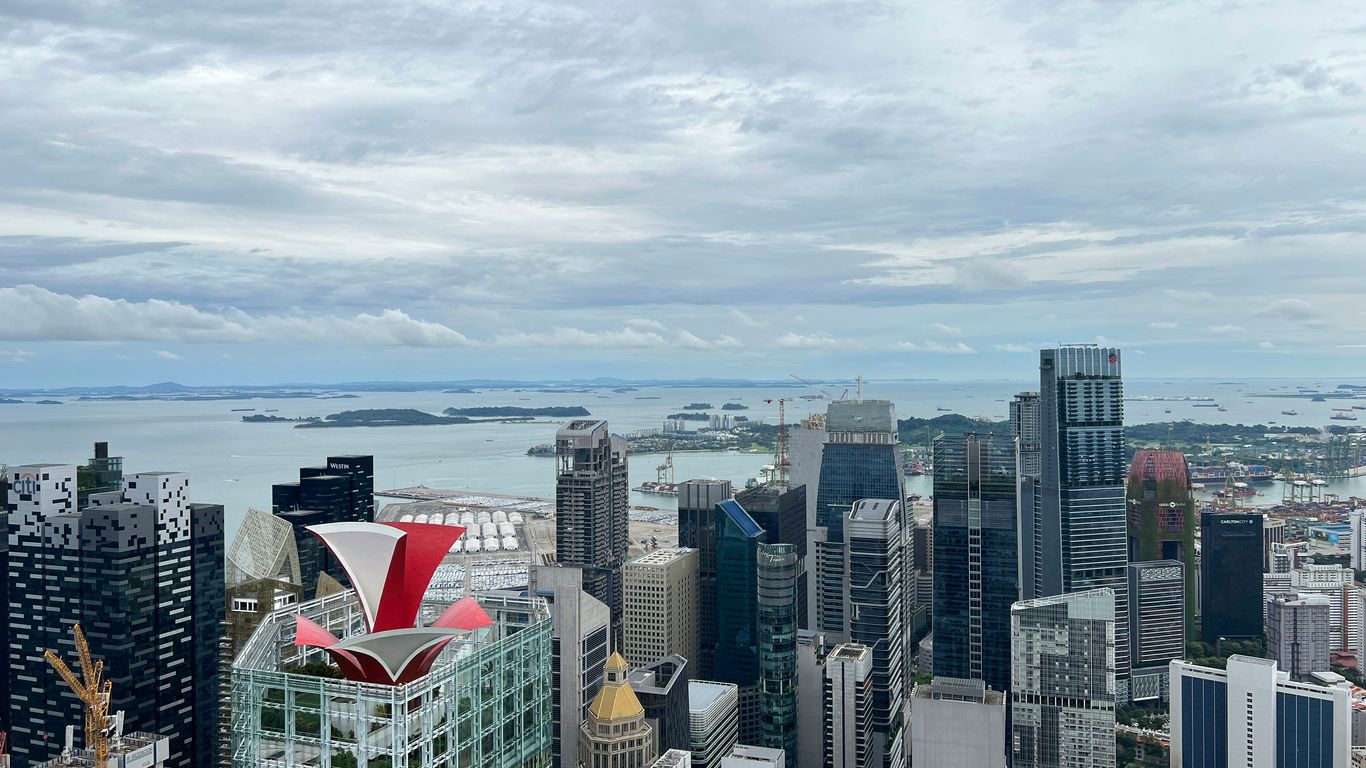 a city with a body of water in the background