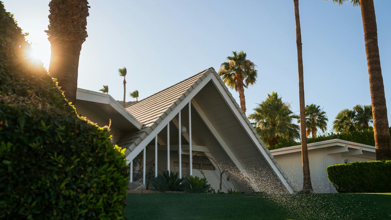 a house with palm trees in the background