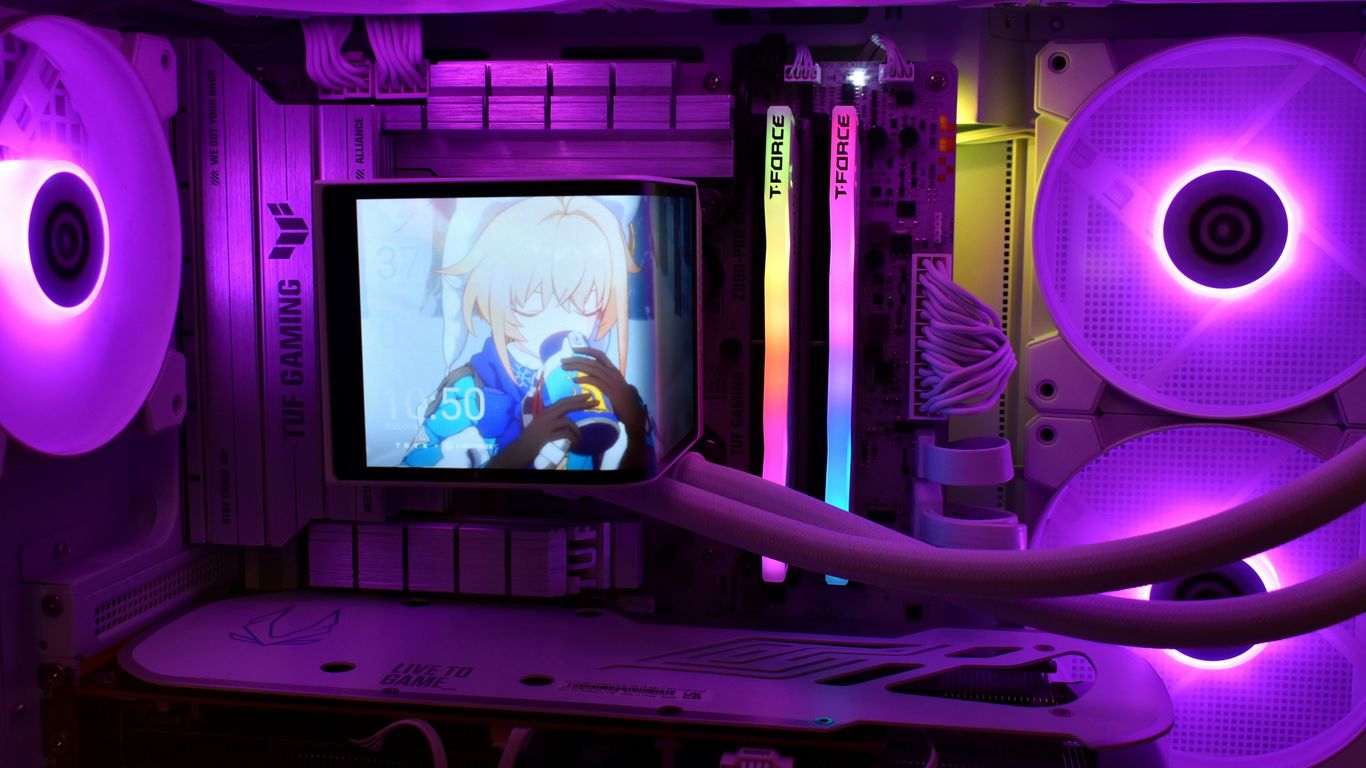 Computer case with purple lighting and small screen.