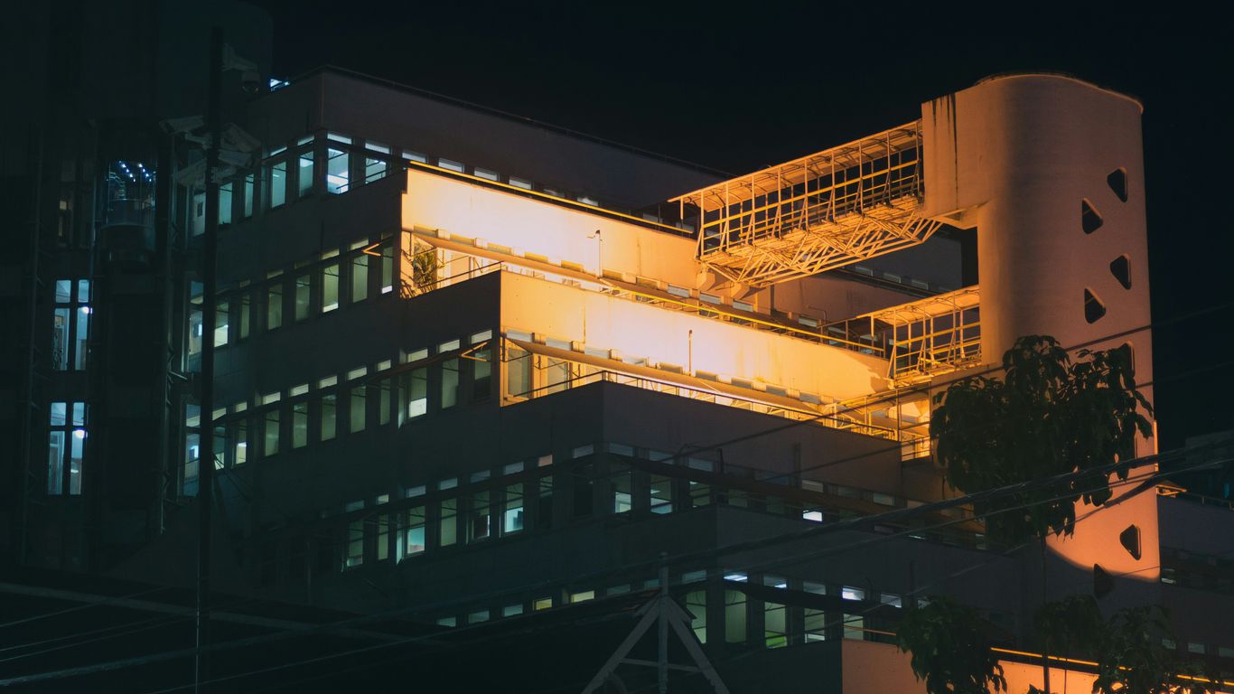 A large building lit up at night time