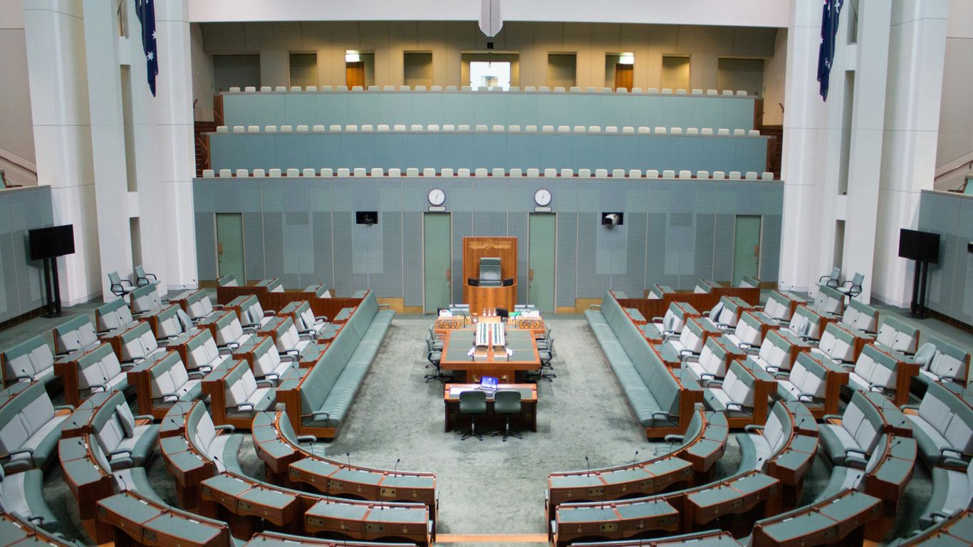 a large room with rows of chairs and a podium