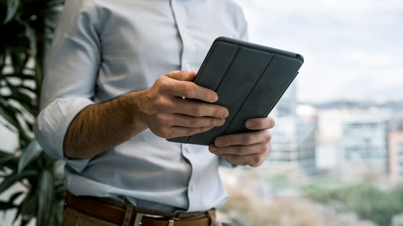 person holding black smart cover during daytime