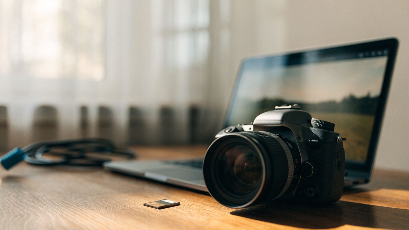 A camera and laptop displaying an image file